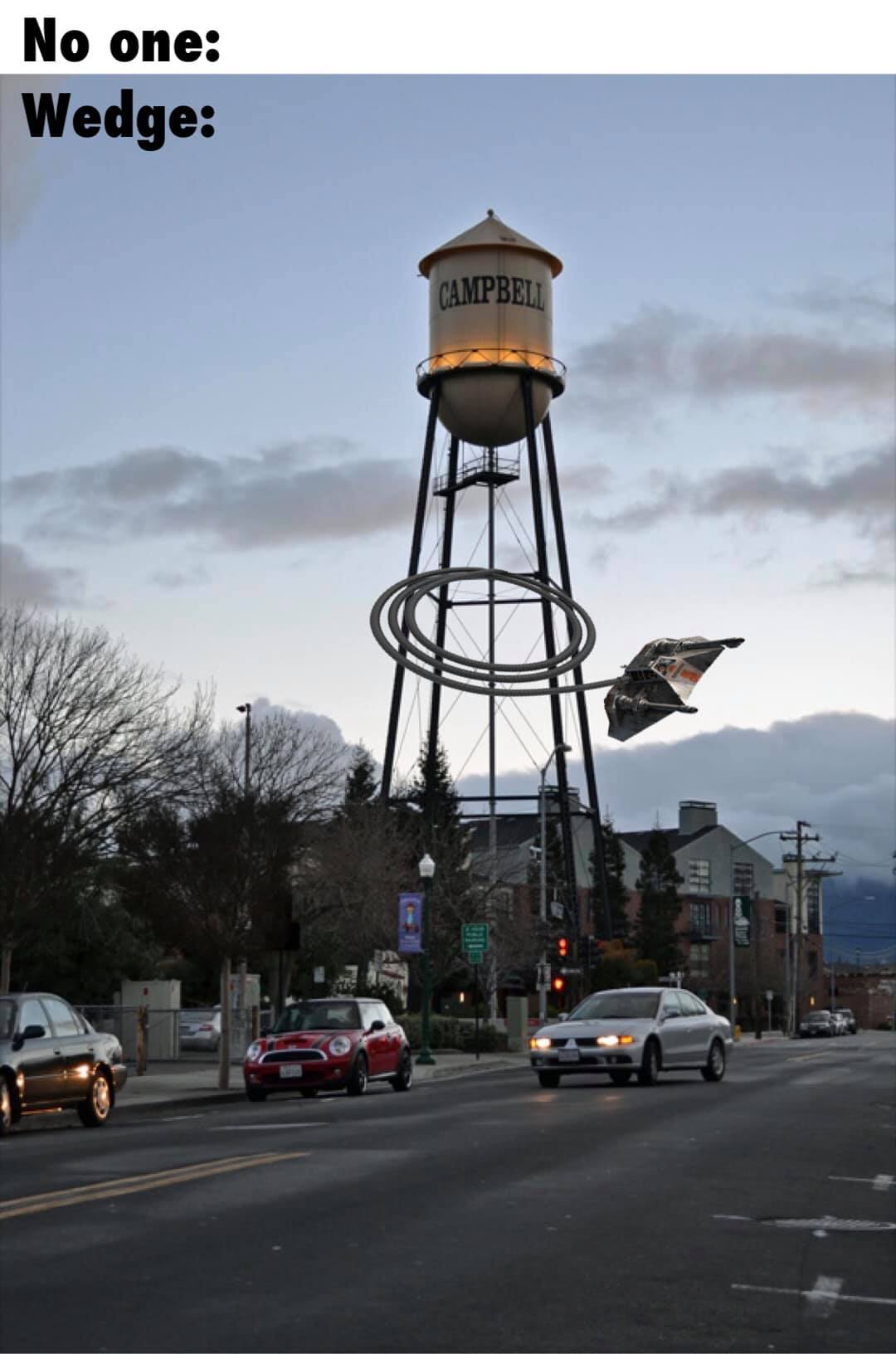 This meme is a play on the phrase "In a world..." often used in movie and book introductions, but with a humorous twist. The image shows a small town with a giant, monstrous, and seemingly impossible object (a giant robot or a spaceship) hovering above it. The text at the top reads "In a world where...".